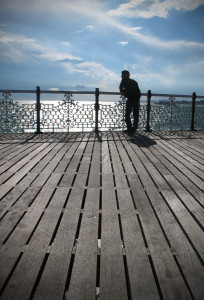 A young man looking into the distance, coast, Brighton, Pier